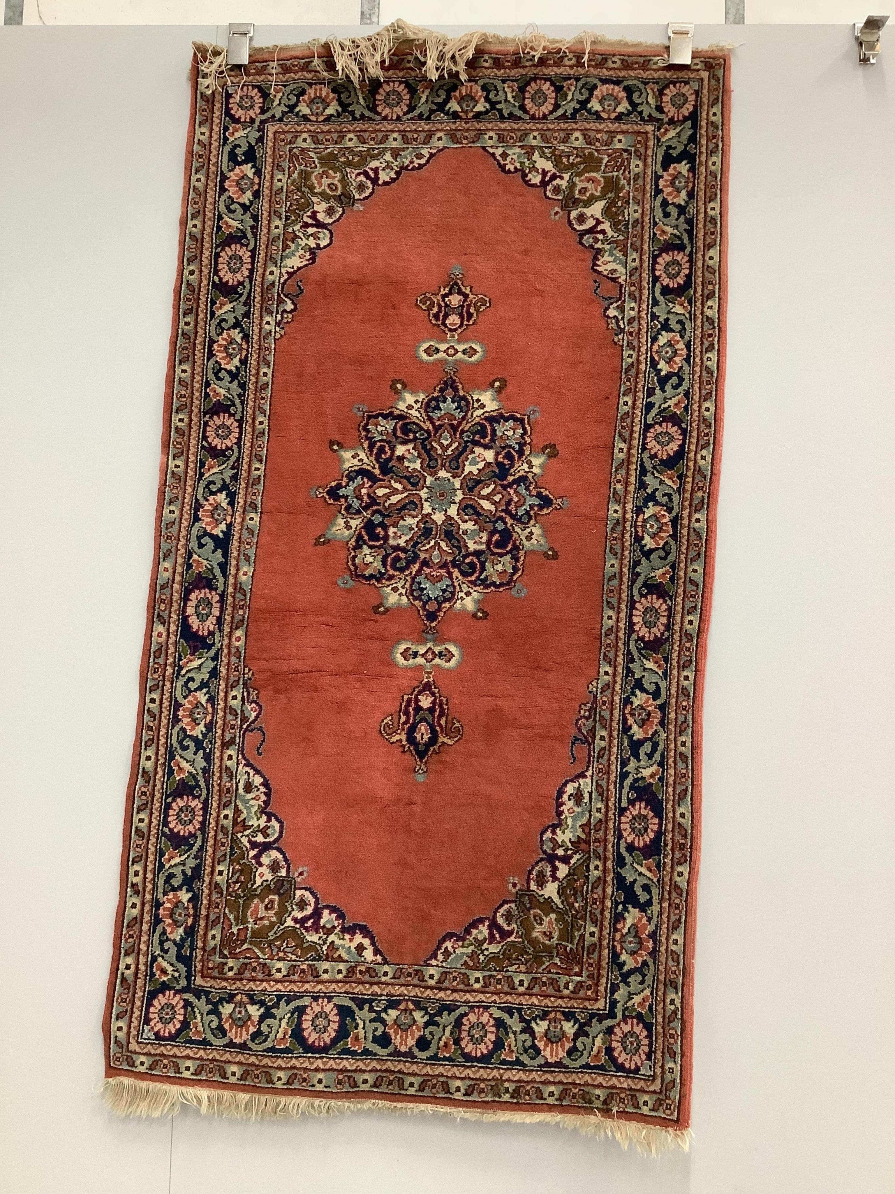 A Turkish ivory ground rug and a similar smaller red ground rug, larger 194 x 141cm. Condition - fair